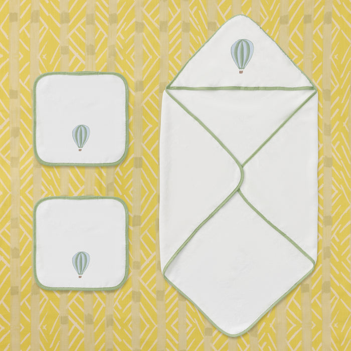 White baby hooded towel and two washcloths with green trim and hot air balloon embroidery.