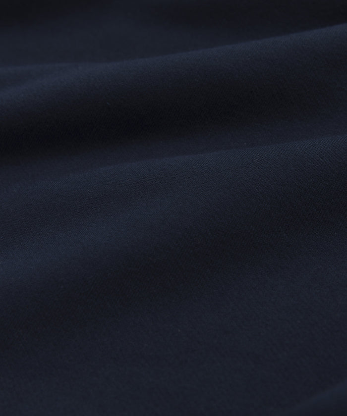 Close-up of Brushed Fleece in rich navy, highlighting the soft, smooth texture and gentle folds of the Bay Hoodie. Subtle shadows and highlights enhance the luxurious look and premium feel of this stylish hoodie.