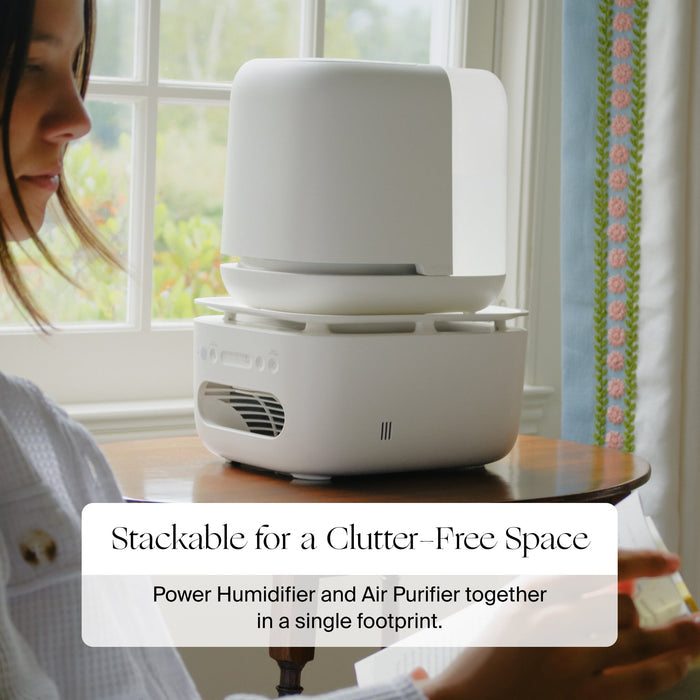 Stackable power humidifier and air purifier on a table with a person in the background.