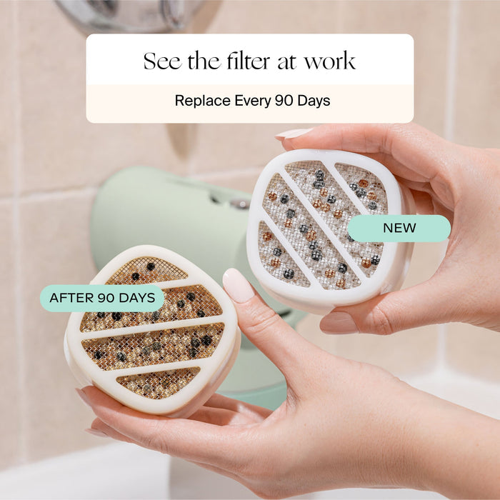 Two air filter cartridges, one new and one after 90 days, held by hands with a bathroom background.