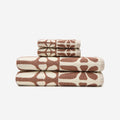 Geometric bath towels, cotton, brown and cream abstract patterns, folded on white background.