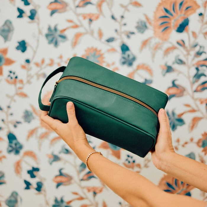 photo of hands holding the Dopp Kit in Hunter Green