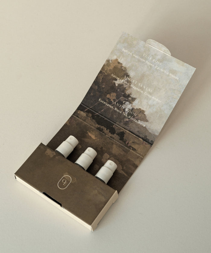 The Eau De Parfum Discovery Set includes three mini spray bottles in a beige and brown case with landscape artwork—an elegant way to sample signature scents.