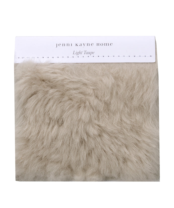 A Fabric Swatch Light Taupe Shearling offers luxurious, faux Icelandic sheep shearling softness in a light taupe hue and complements Jenni Kayne Furniture seamlessly.