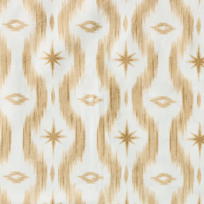 An open Mahjong bag in a tan and cream ikat pattern, filled with peach-colored mahjong tiles.