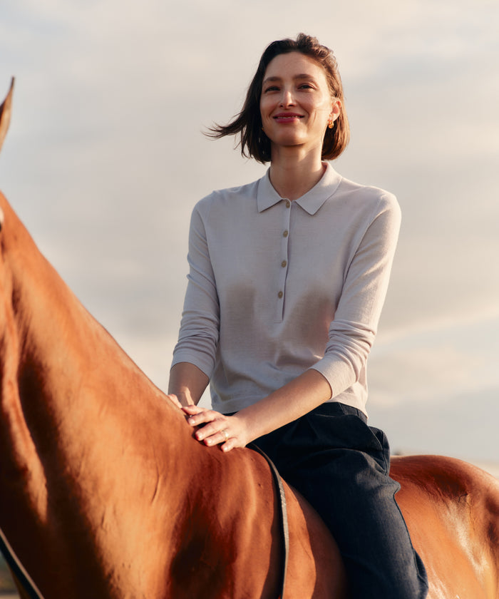 Woman sitting on a horse with a scenic background