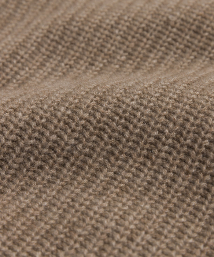 Close-up of the Kids' Cashmere Fisherman sweater in brown, featuring textured, evenly spaced stitches and gentle waves that highlight its soft, cozy cashmere material.