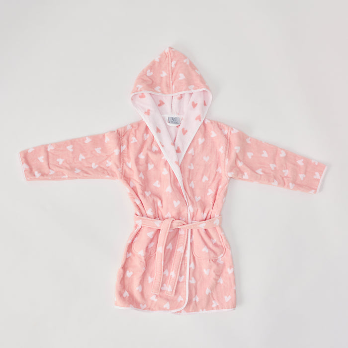 A fluffy coral pink bathrobe with white hearts.