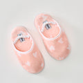 Fluffy coral pink slippers with white hearts and a ruffled elastic strap.