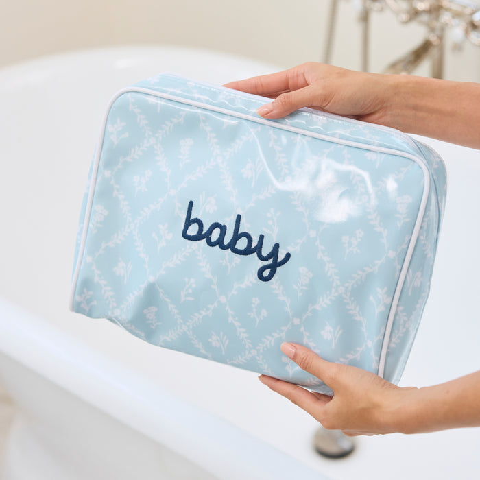 someone holding the large patterned toiletry bag archive Blue Trellis in a bathroom