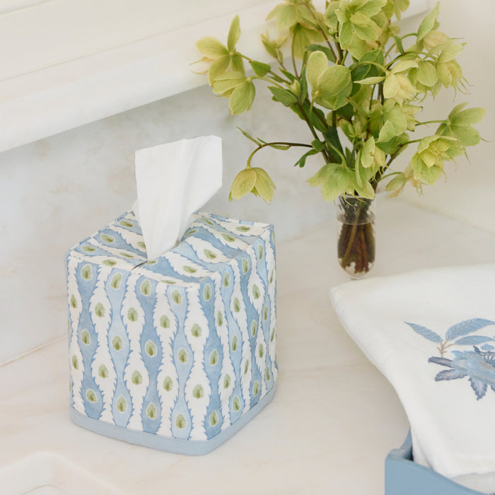 Lee Jofa x Weezie blue and green floral Marciana cotton tissue box cover on a vanity.