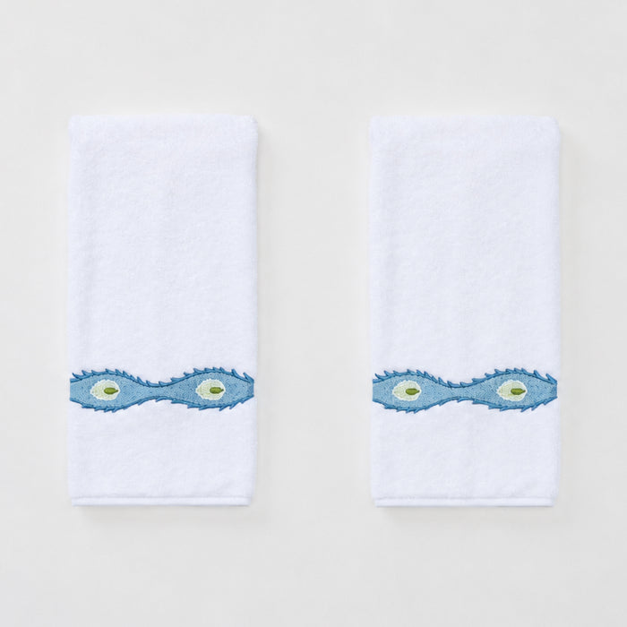 Two white Weezie hand towels with wavy blue Lee Jofa Marciana embroidery on a white background.