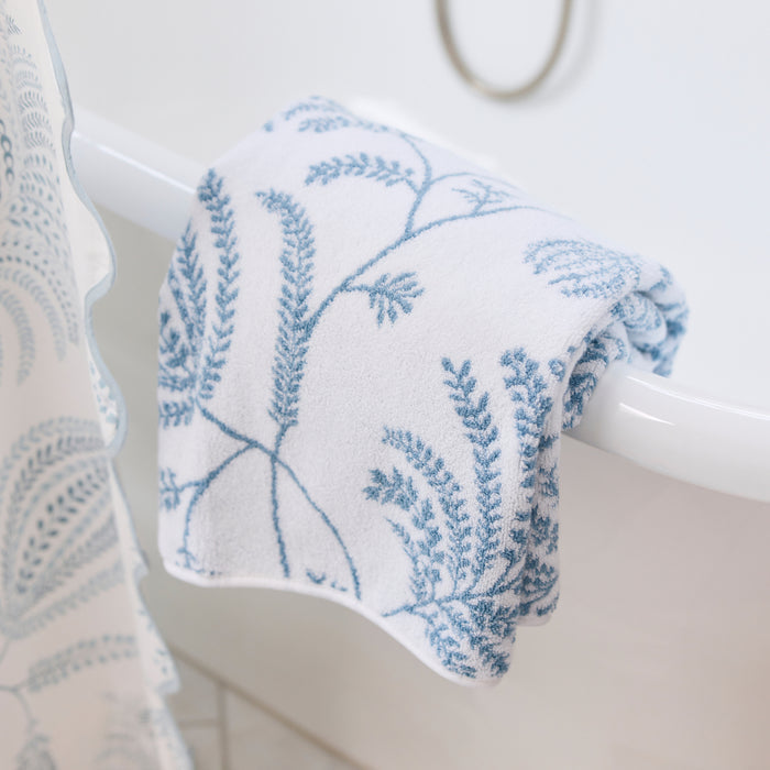 Plush white bath towel with a light blue floral Palmero pattern