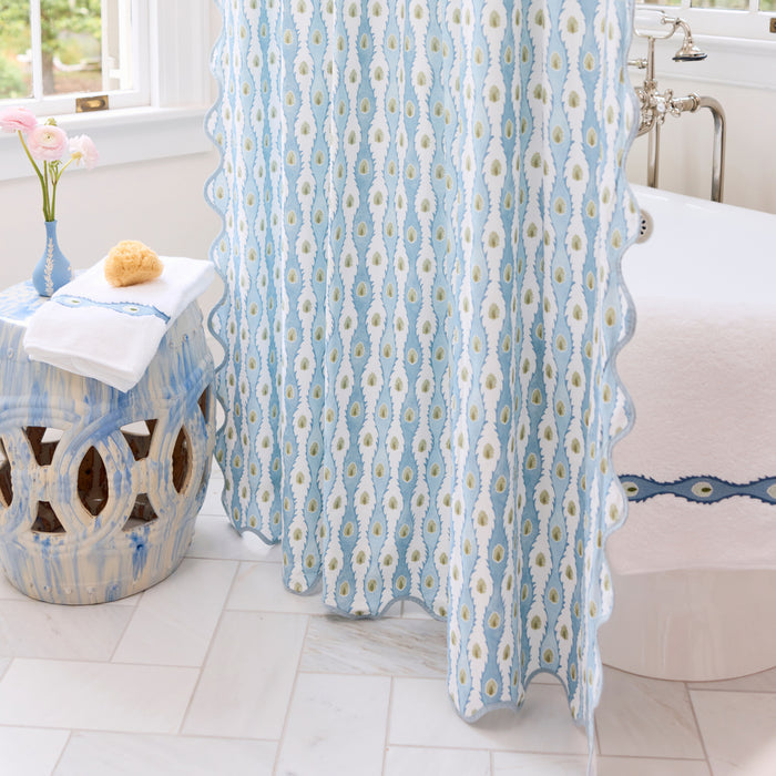 Shower curtain with white and blue Lee Jofa Marciana pattern and blue scalloped trim.