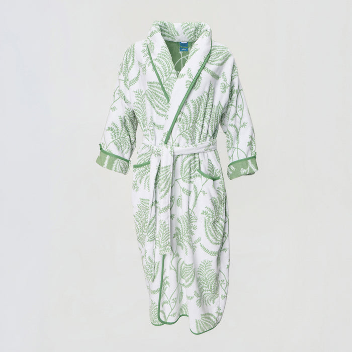 Front view of a white plush robe with a sage green botanical pattern and green piped trim.