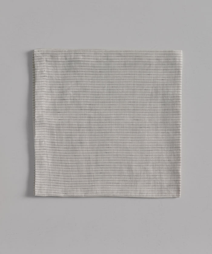 A neatly folded light gray Linen Tablecloth featuring thin horizontal stripes and a subtle black stripe, displayed on a flat light gray background.