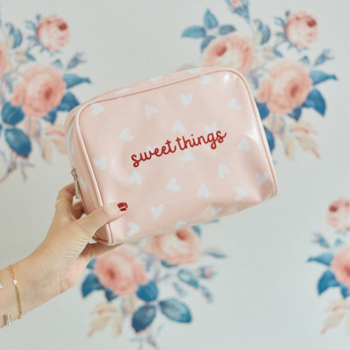 A photo of the small patterned toiletry bag archive in Tossed Pink Hearts