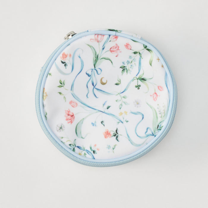 A round zippered pouch with a white background and a delicate pastel floral print featuring light blue ribbons, pink flowers, and green leaves, finished with a light blue zipper.