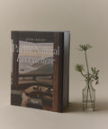 Book titled 'Pacific Natural Everywhere' by Jenni Kayne with a vase of flowers on a neutral background