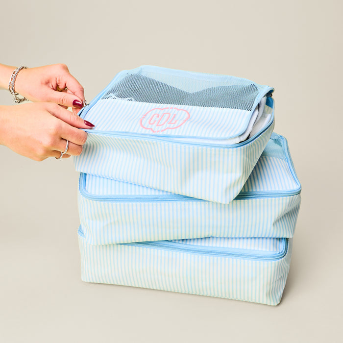 the packing cube bundle in Heritage Blue Stripe, stacked on top of each other