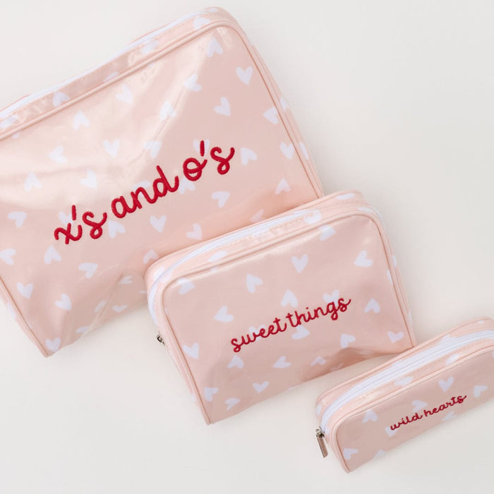 photo of the patterned toiletry bag trio (large, small, and medium) in Tossed Pink Hearts Archive