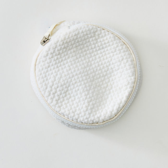 A round white textured fabric pouch with a zipper closure, shown on a plain white background.