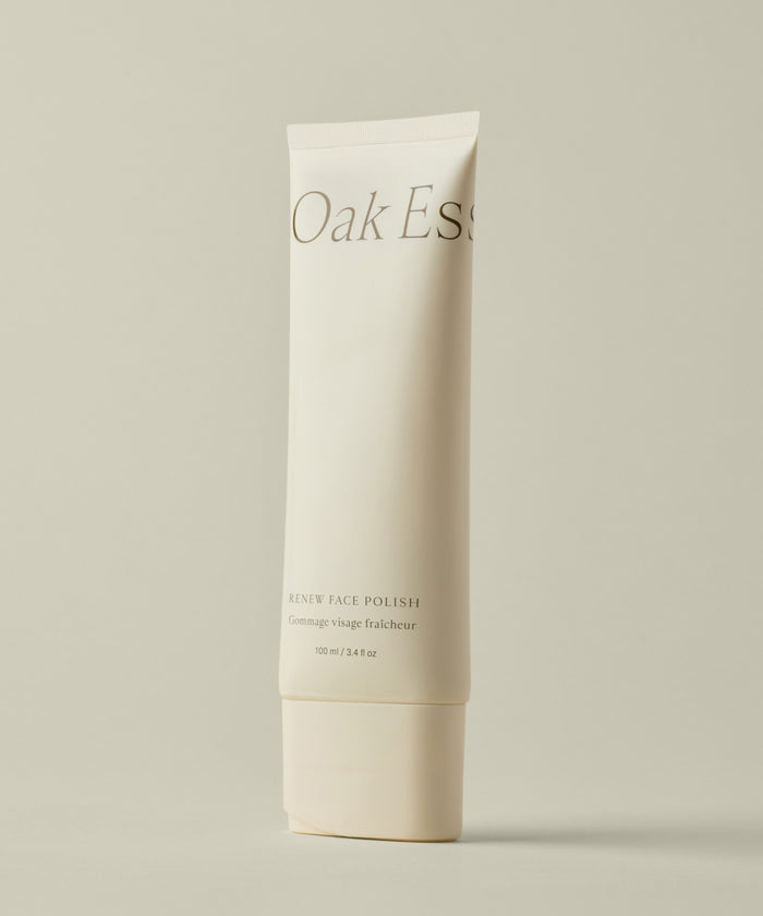 A beige tube of Renew Face Polish stands upright against a plain, light beige background. The 100 ml (3.4 fl oz) tube features upcycled pineapple exfoliants for gentle, eco-friendly skin renewal.