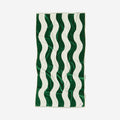 Cotton towel with green and white wavy stripes, laid flat.