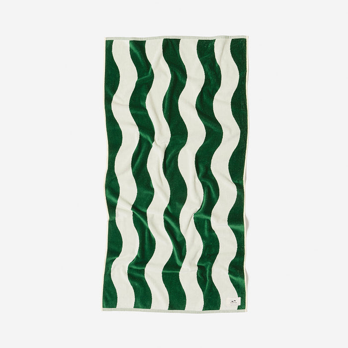 Cotton towel with green and white wavy stripes, laid flat.