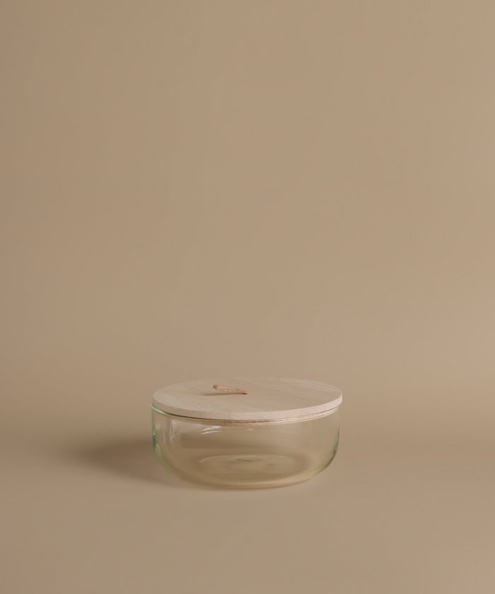 Glass canisters against a beige background.