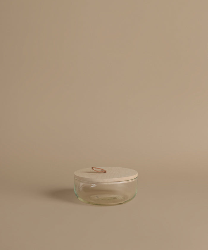 Glass canisters against a beige background.