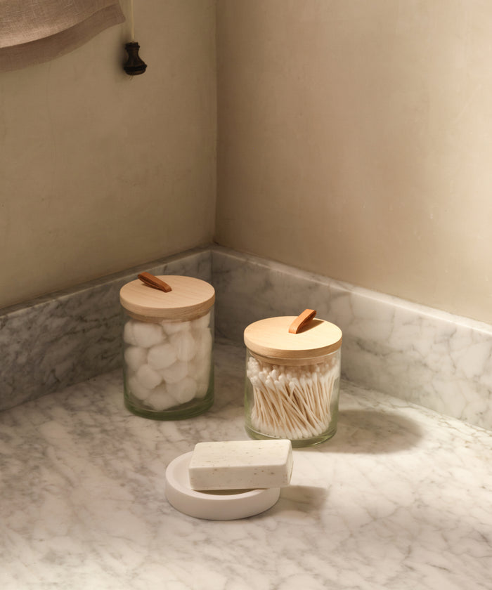 Glass canisters in a bathroom.