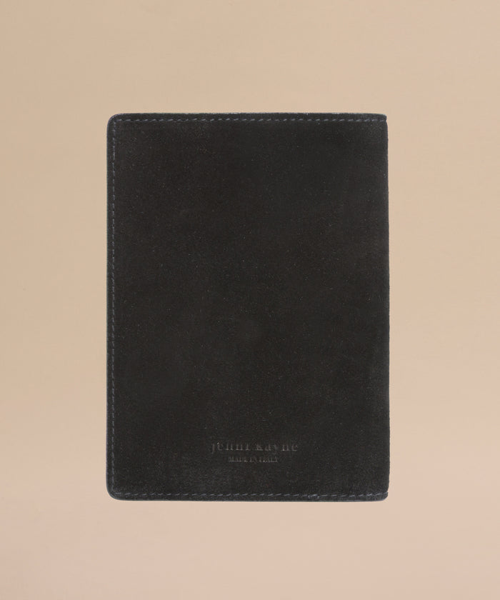 The Suede Passport Holder in black features subtle edge stitching and is displayed on a light beige background—an elegant touch for your travel essentials.