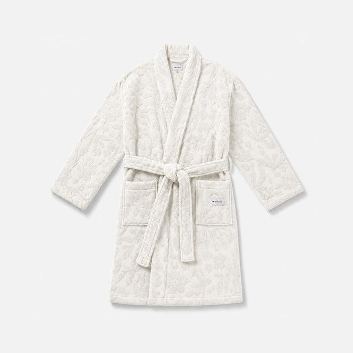 White textured bathrobe with belt and two front pockets for cozy homewear.