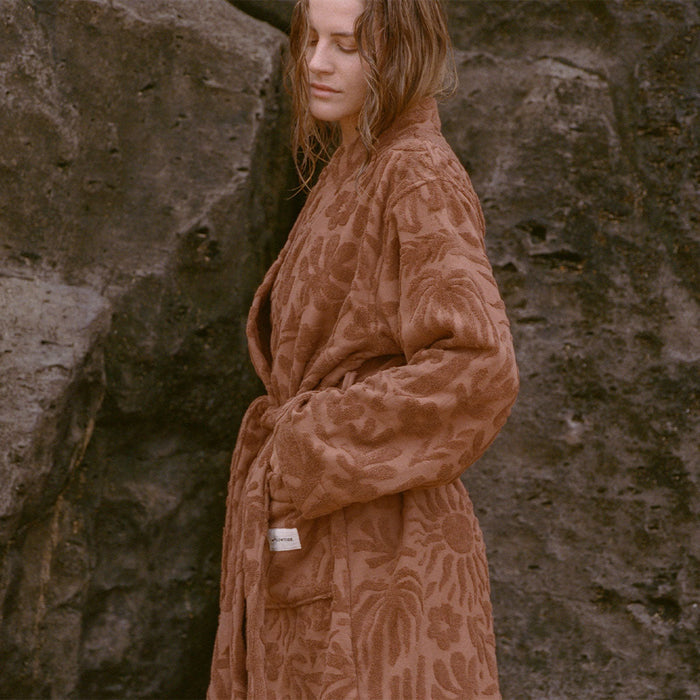 Brown patterned robe with pockets, lightweight fabric.