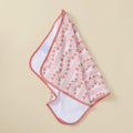 A hanging kitchen towel featuring a pink and peach floral climbing vine pattern and solid pink trim.