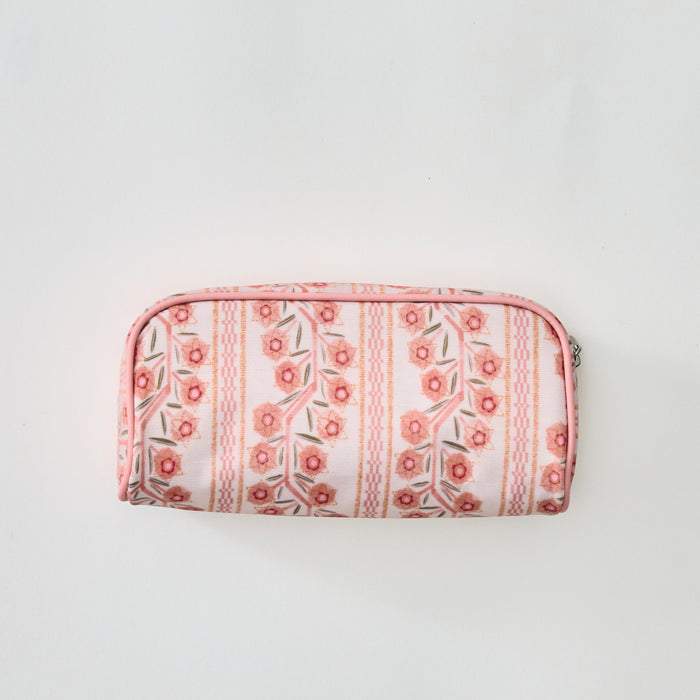 A small zippered toiletry bag featuring a pink and coral floral climbing vine pattern, shown centered against a plain light background.