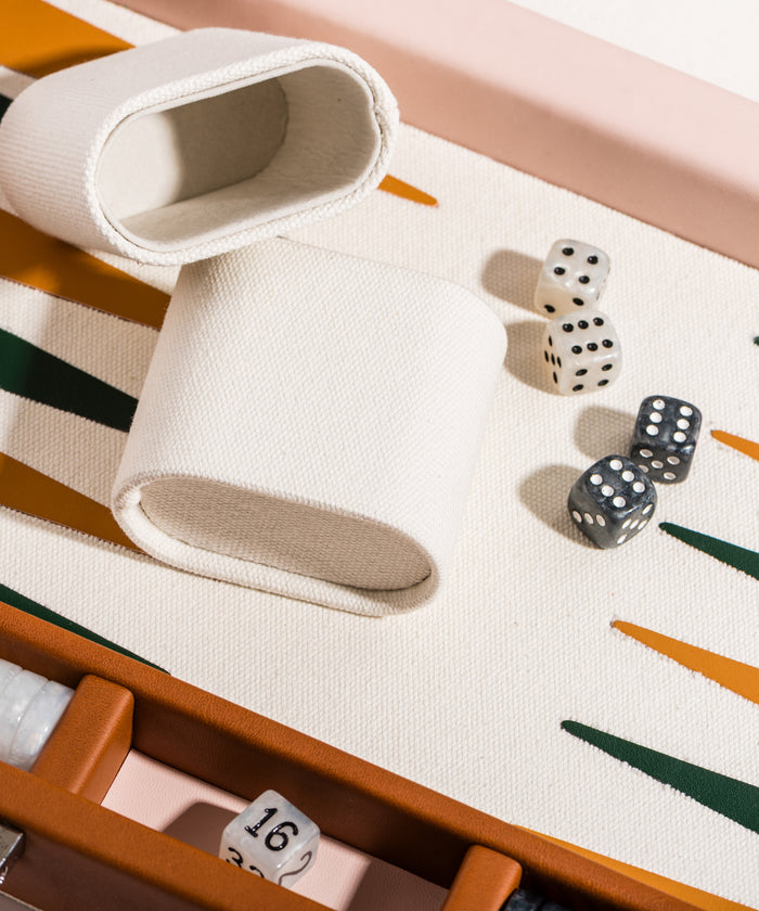 Backgammon board with dice and pieces on a patterned surface