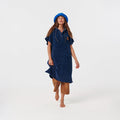 Blue hooded towel poncho with tan pants and blue hat.