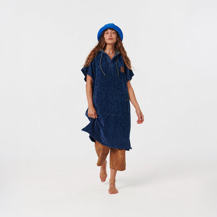 Blue hooded towel poncho with tan pants and blue hat.