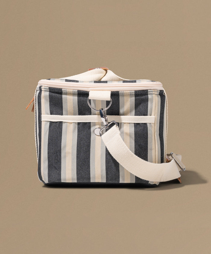 Striped bag with a white strap on a beige background