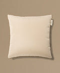 Beige pillow with a tag on a beige background