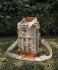 Canvas bag with leather accents on grass
