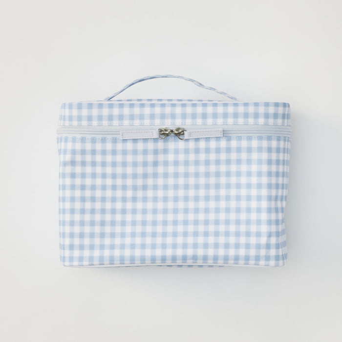 A light blue gingham print vanity case shown from a straight-on, front-facing view against a neutral background. The case features a sturdy top handle and a zippered closure with two silver pulls.