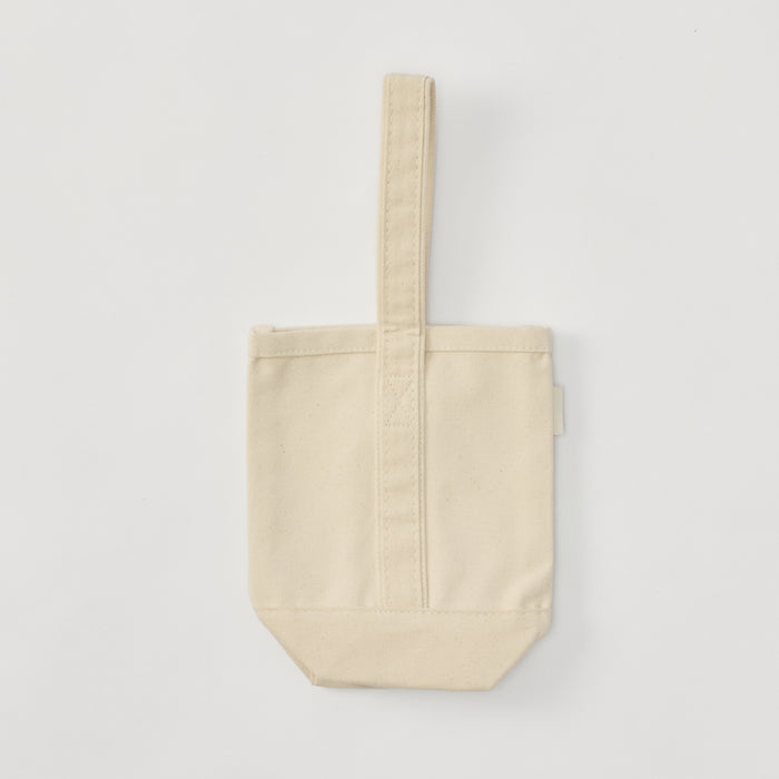 Blank cream colored canvas wine bottle tote bag featuring a single center carry strap.